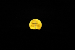 Full moon behind cross in Sandhills